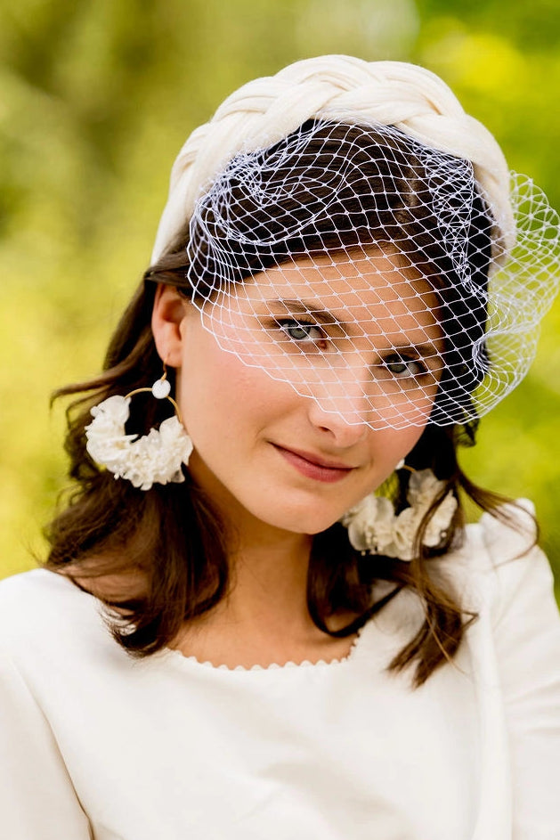 Mariée avec boucles d'oreilles en fleurs séchées et stabilisées blanches montés sur créoles. Créé par Bellemond.